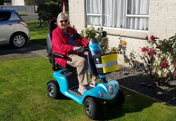 Shirley on her blue mobility scooter